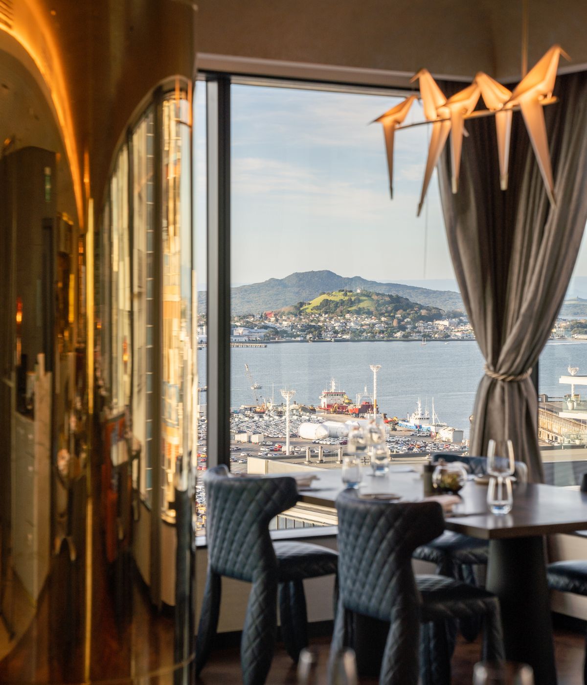 A table with 4 seats at the restaurant next to a large window with view over the harbour